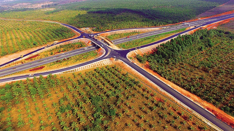 西线高速公路儋州段至东坡书院旅游公路，铺设在绿荫花海犹如一幅画.jpg